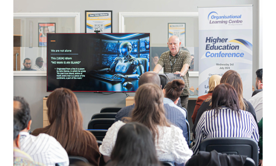 A speaker presenting to students with an OLC HE conference banner