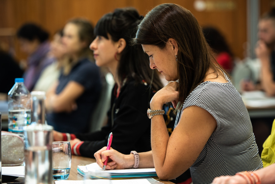 Woman writing notes in learning environment