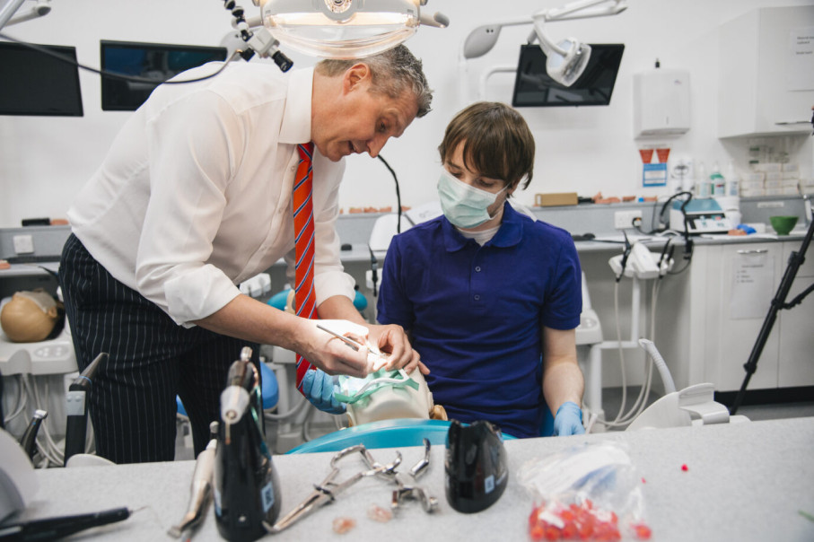 Student and teacher in dentistry lab setting 