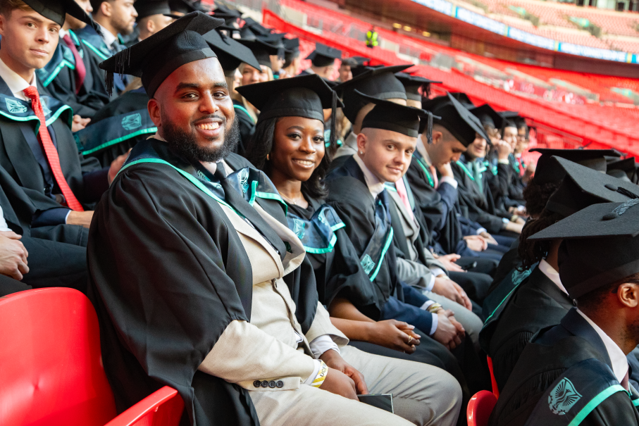Graduates seated in football stadium