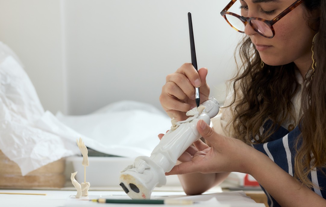 Female artist painting pottery sculpture