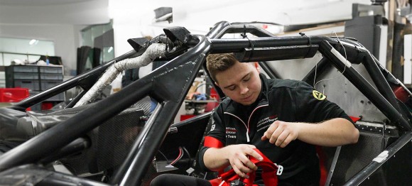 engineer working on race car chasis