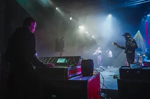 sound engineer at side stage of band