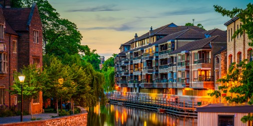 Dusk view of river with buildings and trees