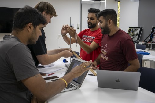 Male students in engineering classroom setting
