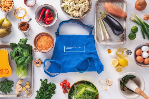 Leiths blue apron surrounded by food