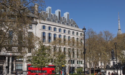 Image of NYU London on the Strand with a red double decker bus