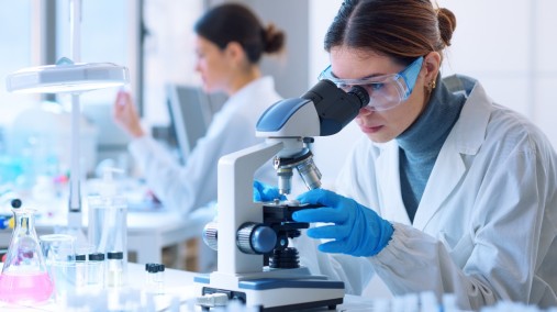 Women scientist using microscope