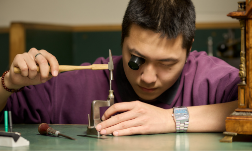 Student inspects clockwork
