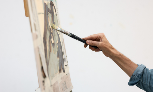 Student paints on canvas