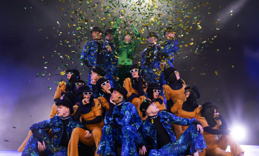 Group of performers with confetti raining down