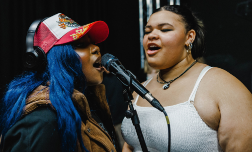 Two singers at a microphone