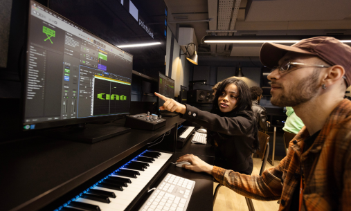 Two students working on music recording software