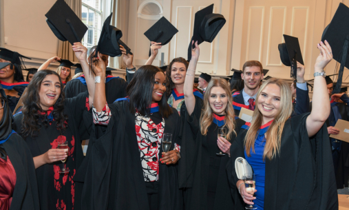 Graduates holding up their hats